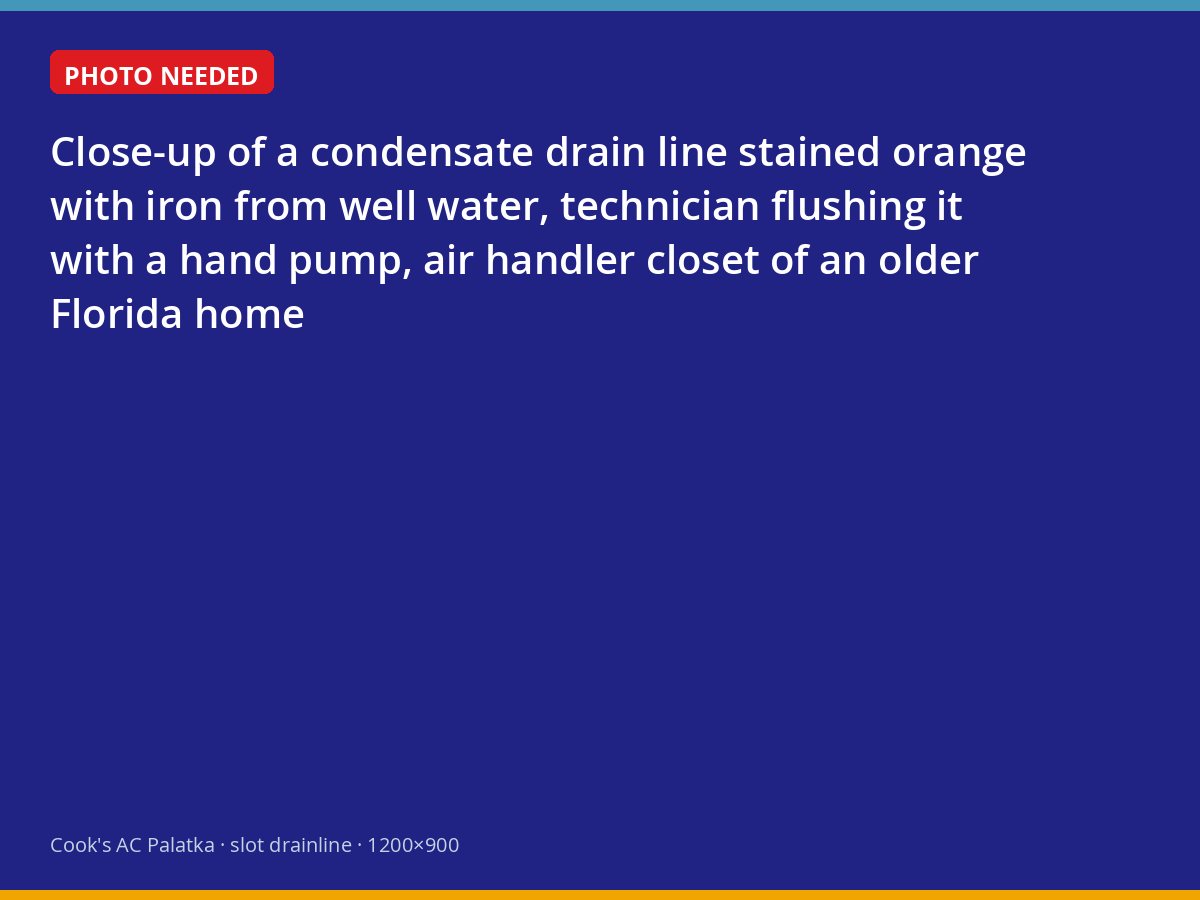 Iron-stained condensate drain line being flushed in a Palatka air handler closet